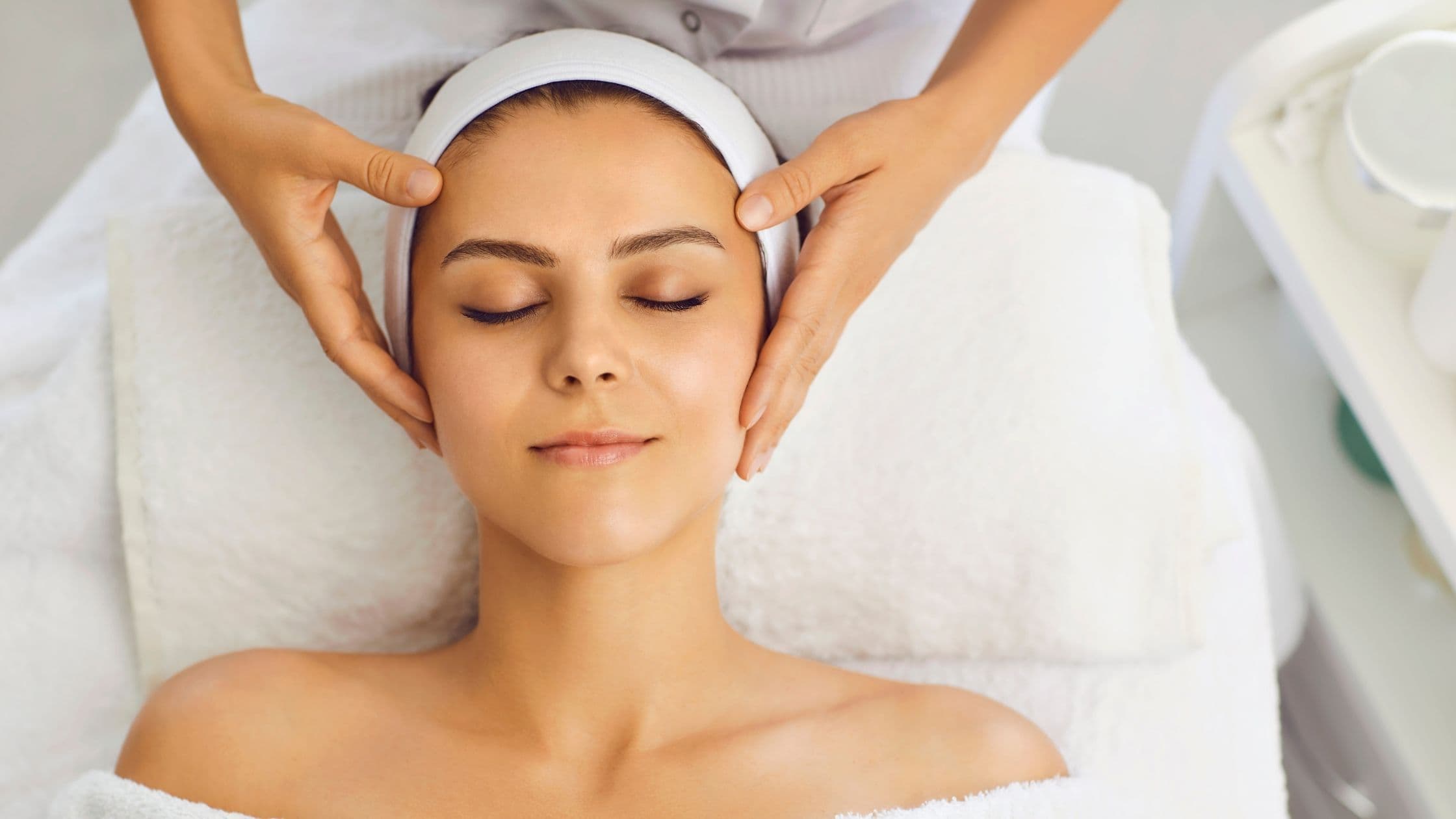 a woman is getting a facial massage at a spa .