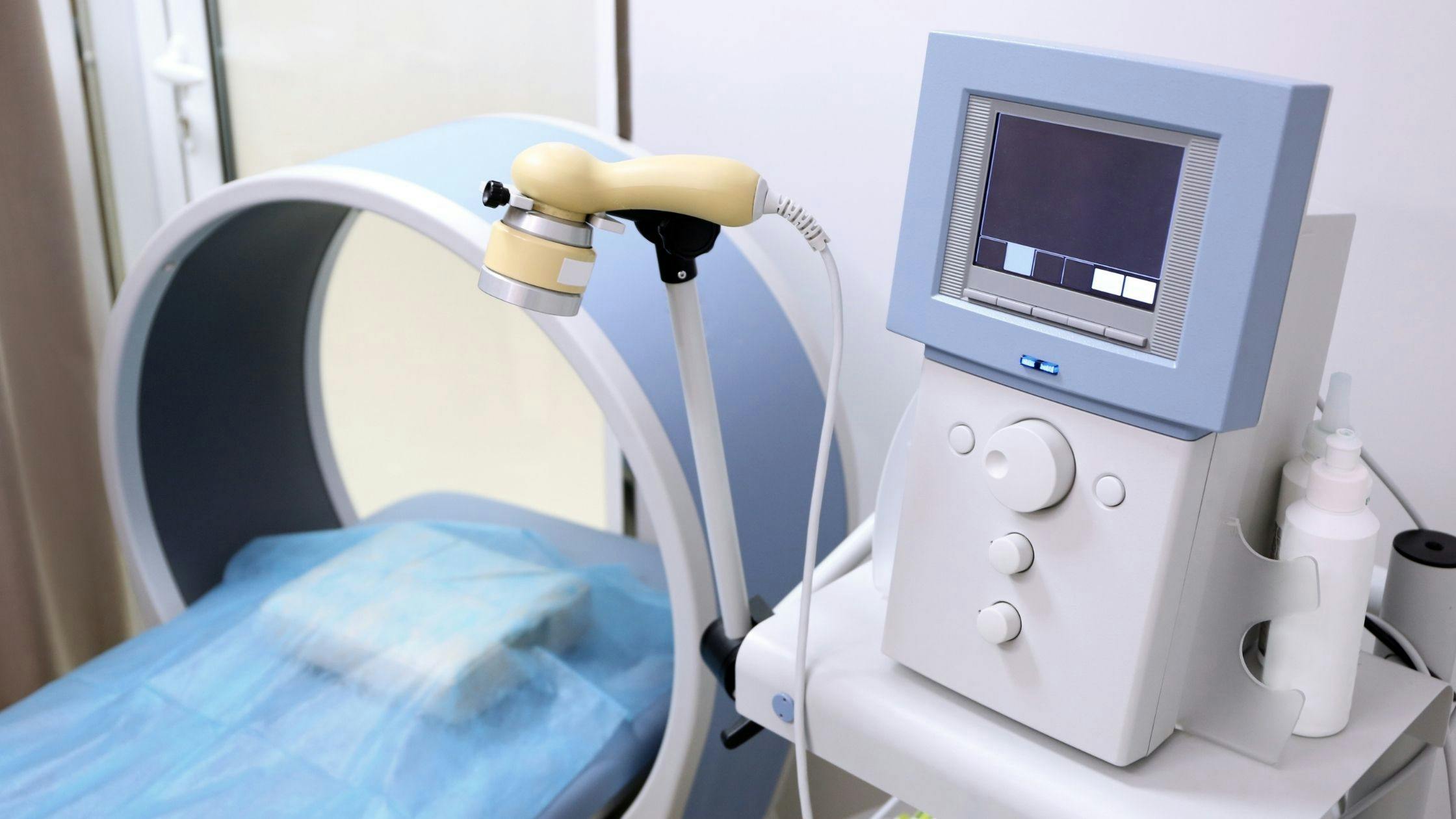 a machine is sitting on a table next to a bed in a hospital room .
