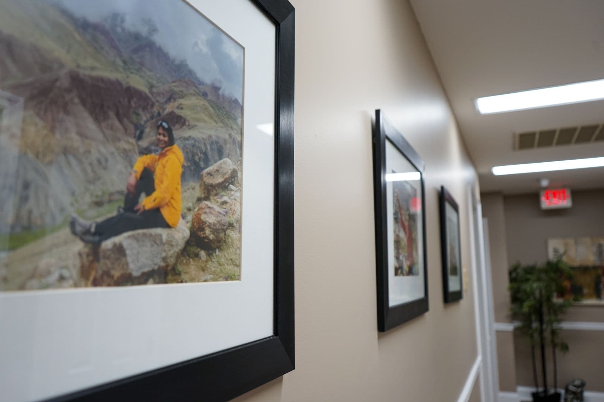 Dr. Vijitha Prasad is sitting on a rock in a picture on a wall at South Georgia Internal Medicine at Swainsboro .