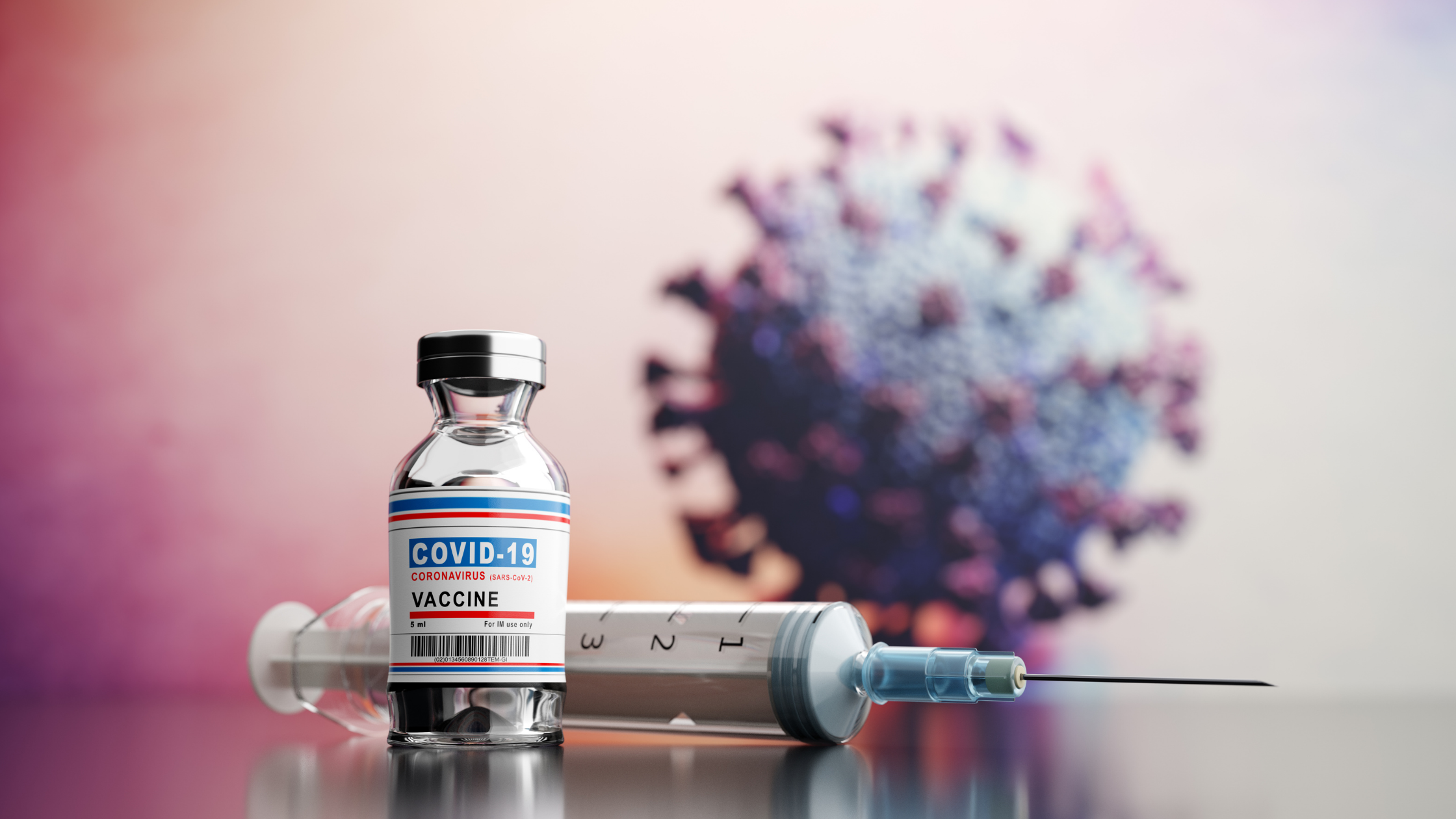 a bottle of covid-19 vaccine next to a syringe