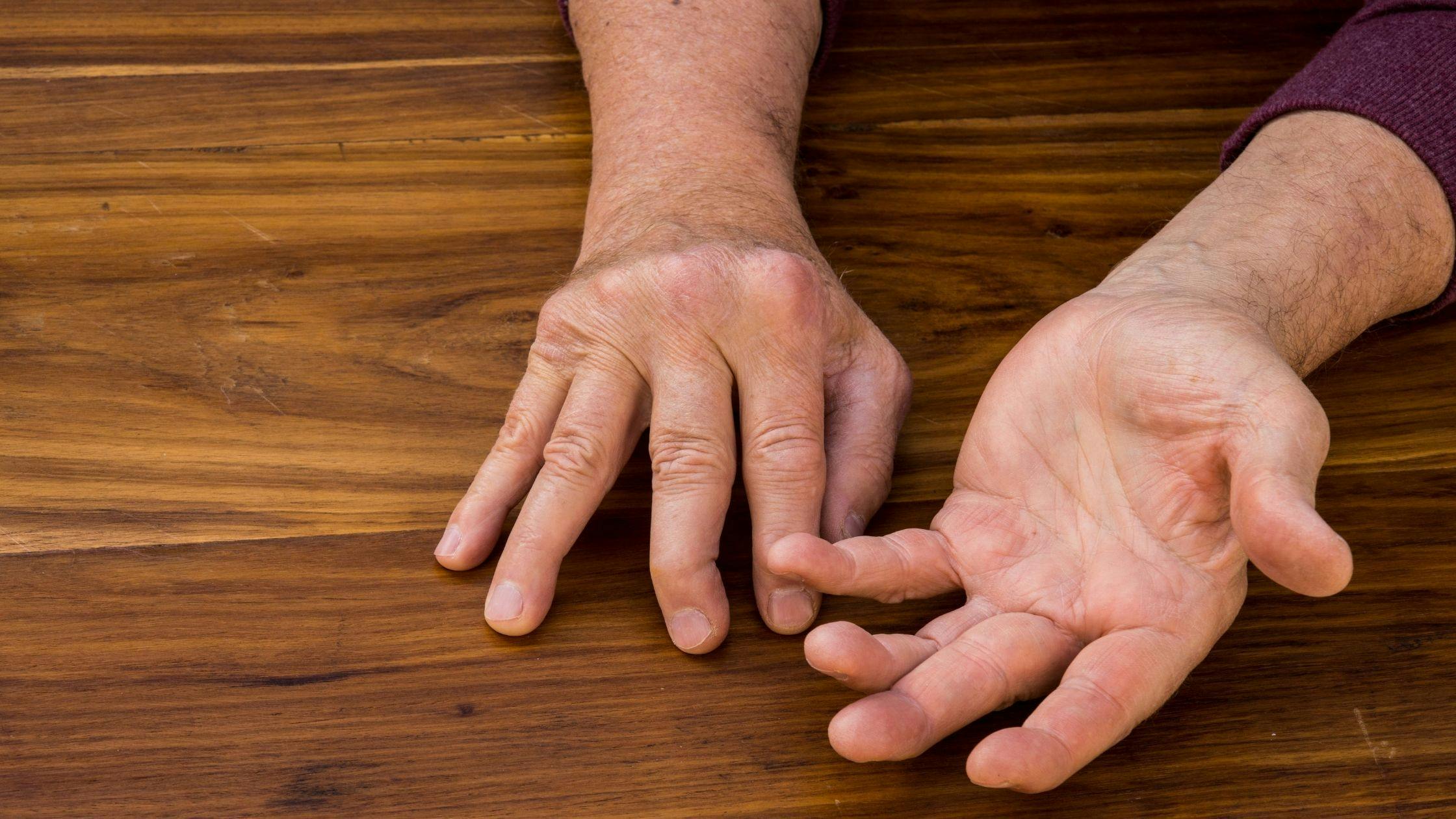 a close up of a person 's hands on a wooden table .