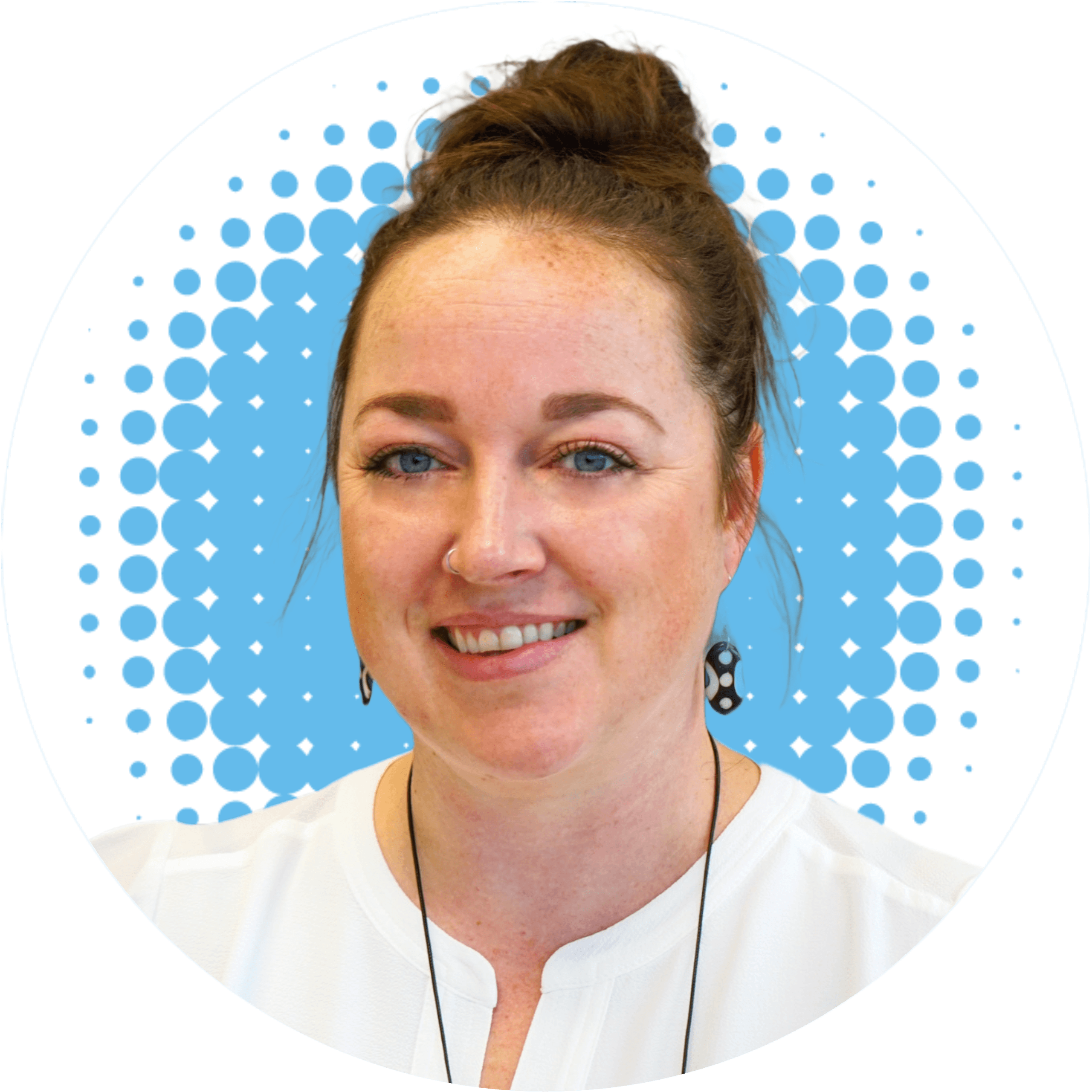 a woman in a white shirt is smiling in front of a blue polka dot background