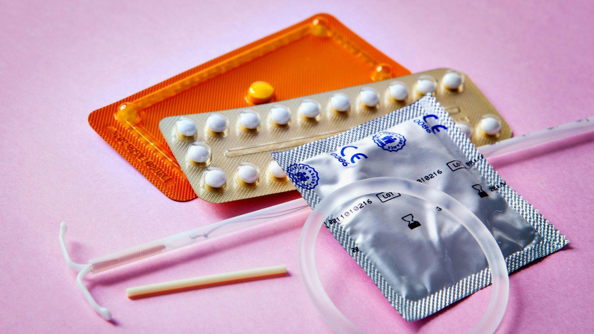 birth control - there are many different types of contraceptives on a pink surface