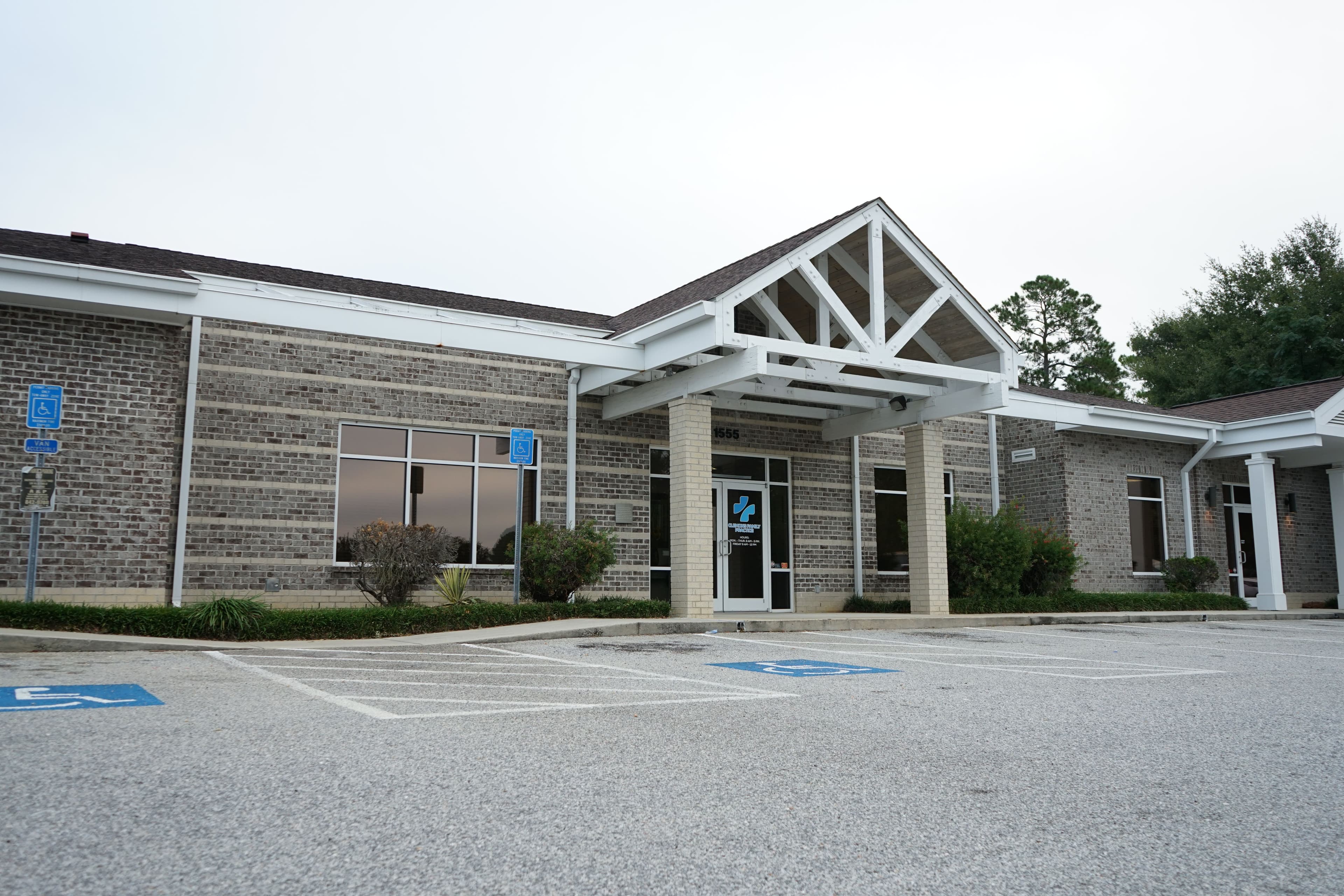 a large brick building with a handicapped parking spot in front of it .