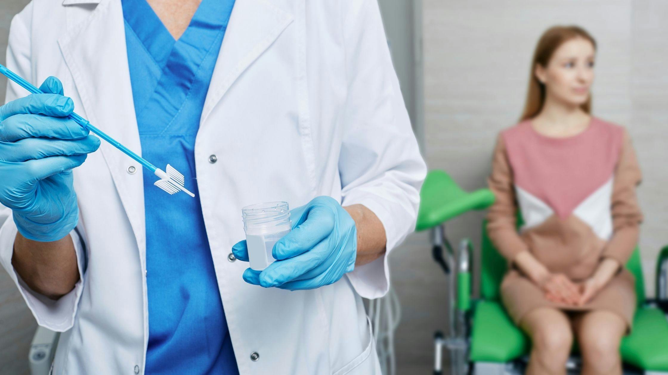 a doctor is holding a swab and a bottle of liquid in front of a patient .