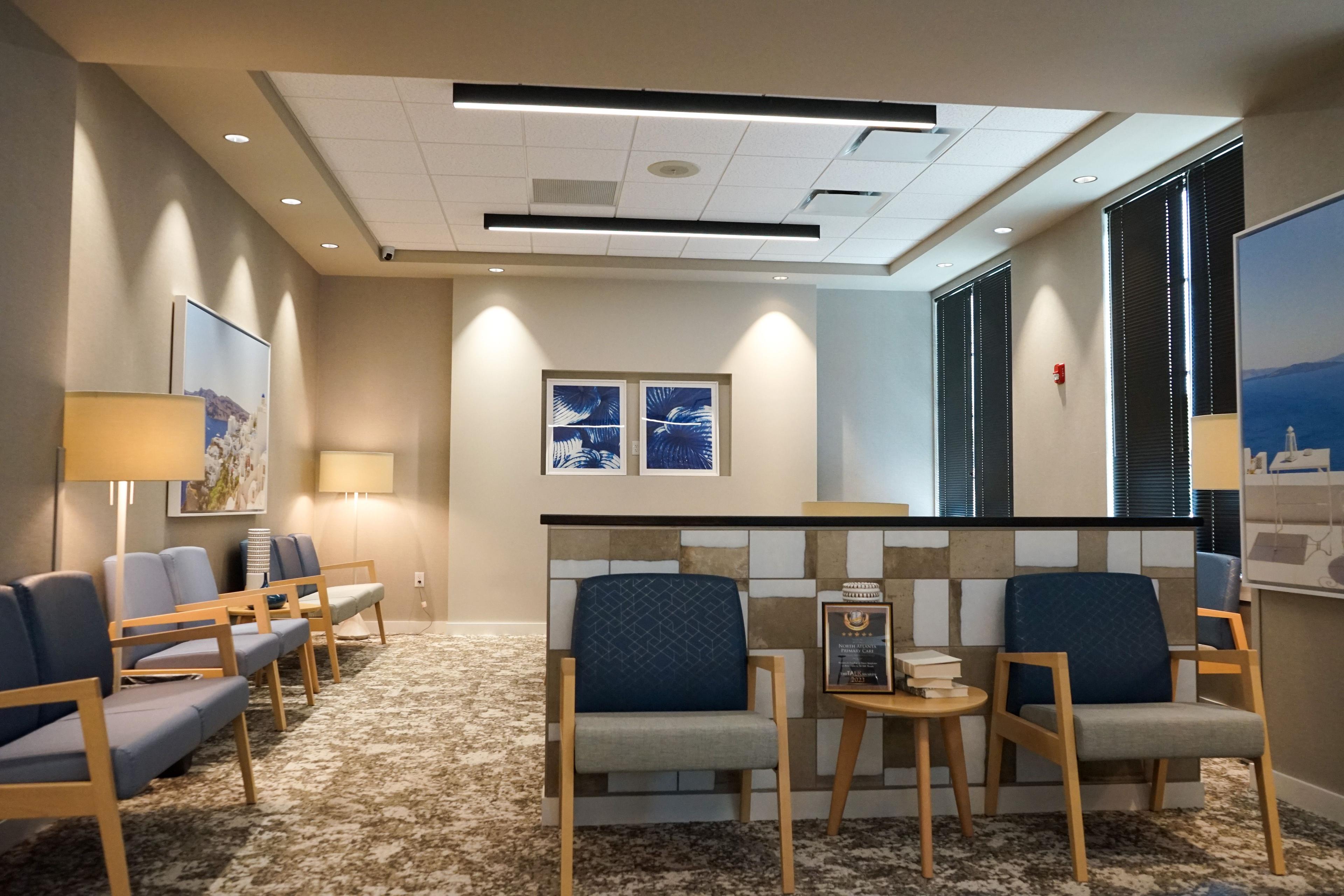 a waiting room with chairs and a counter in a hospital .