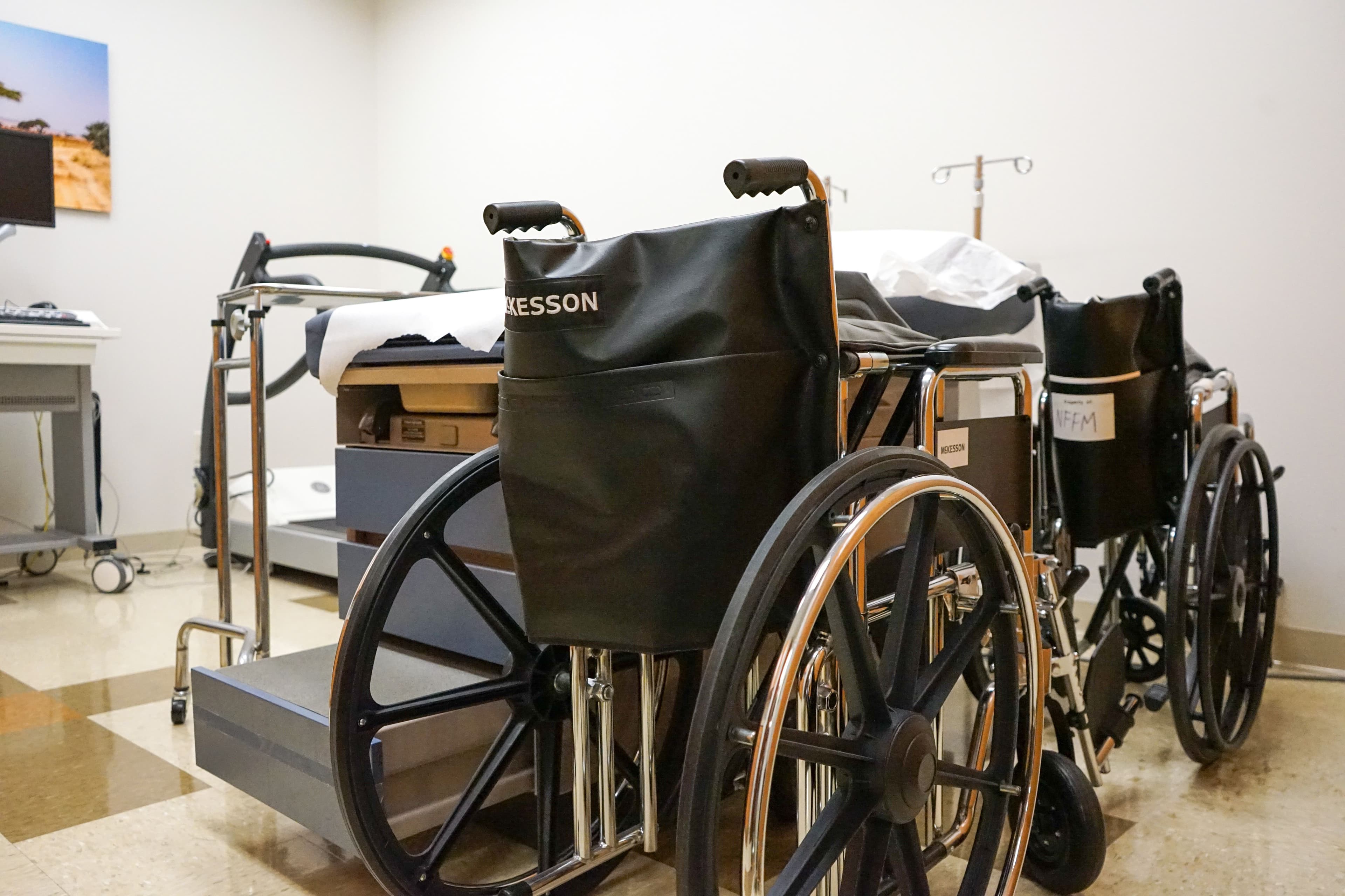 two wheelchairs are sitting next to each other in a hospital room .