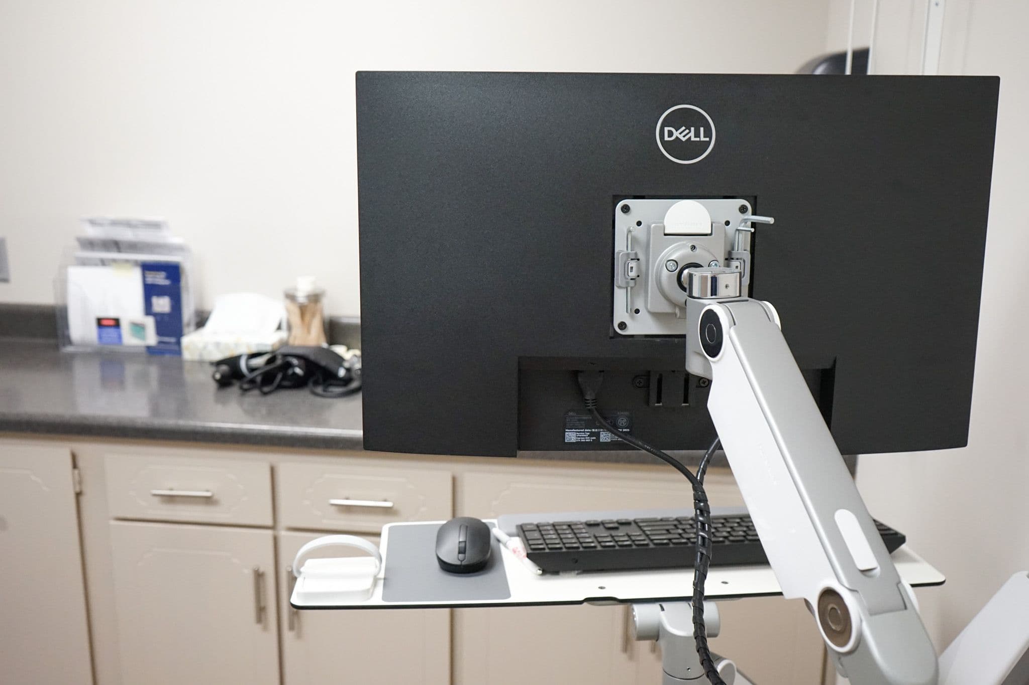 a dell computer monitor is sitting on top of a desk with a keyboard and mouse .