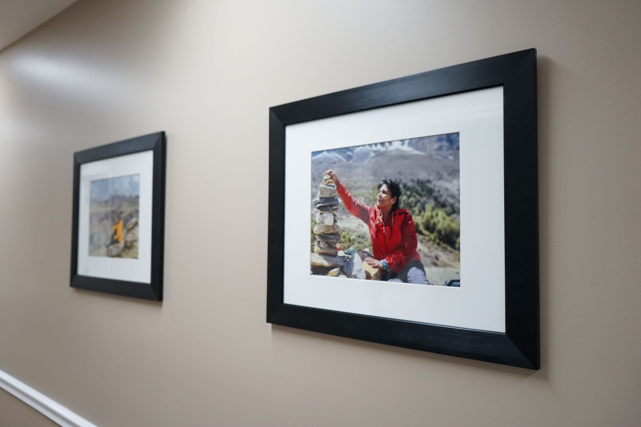 two framed pictures are hanging on a wall in a hallway at South Georgia Internal Medicine at Swainsboro .