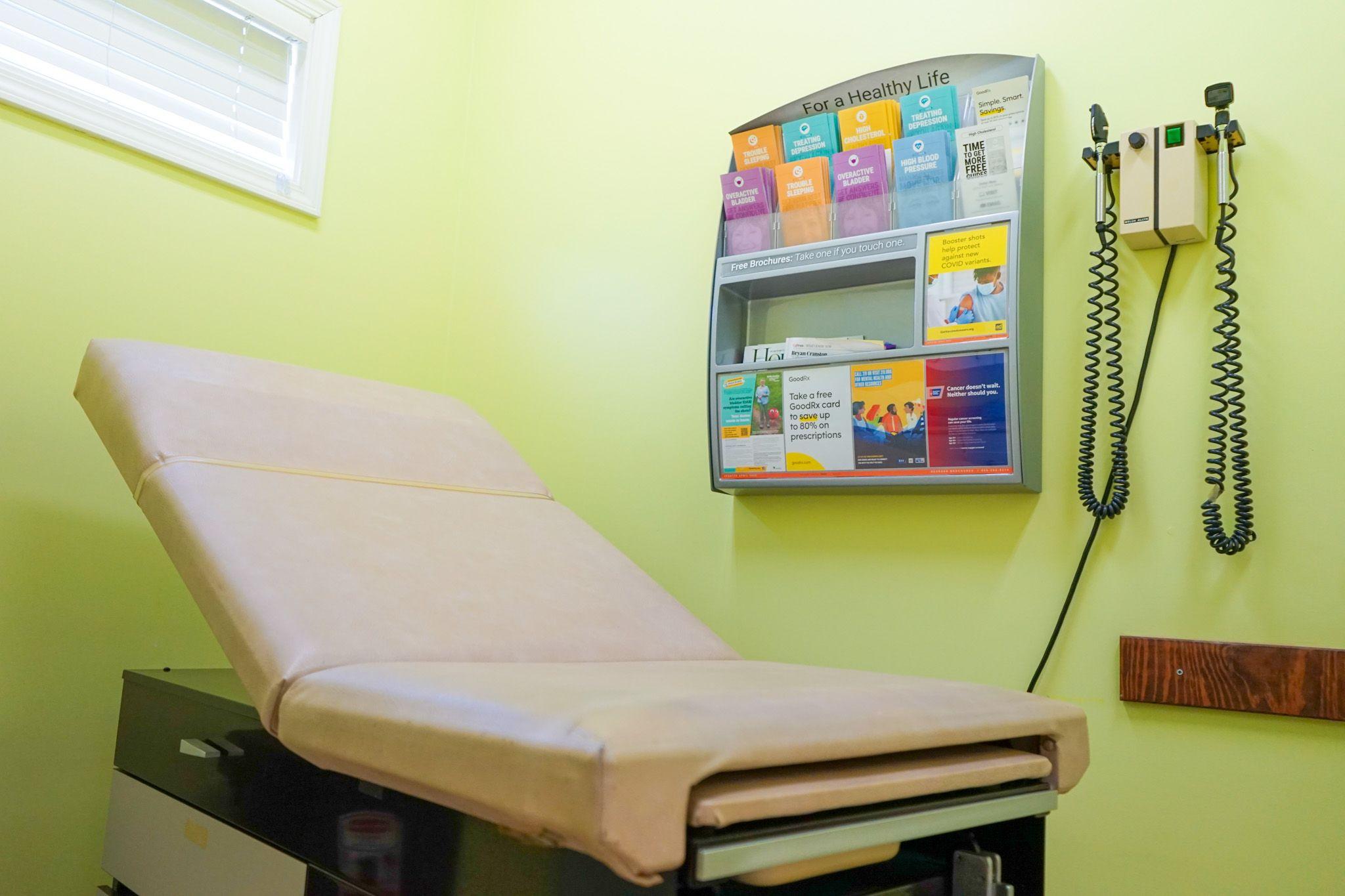 a doctor 's office with a examination table and a stethoscope .