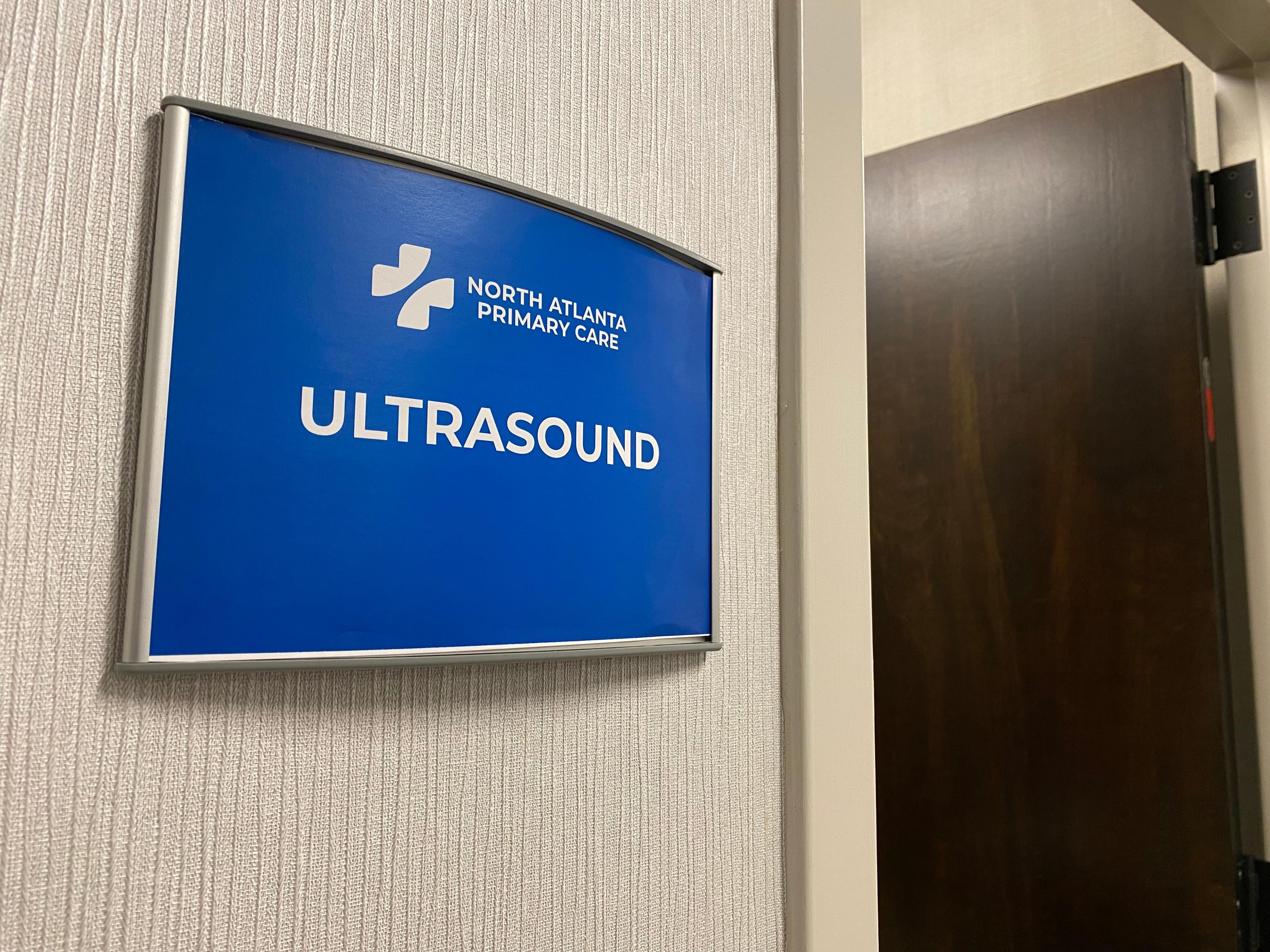 there is a blue sign on the wall that says ultrasound .