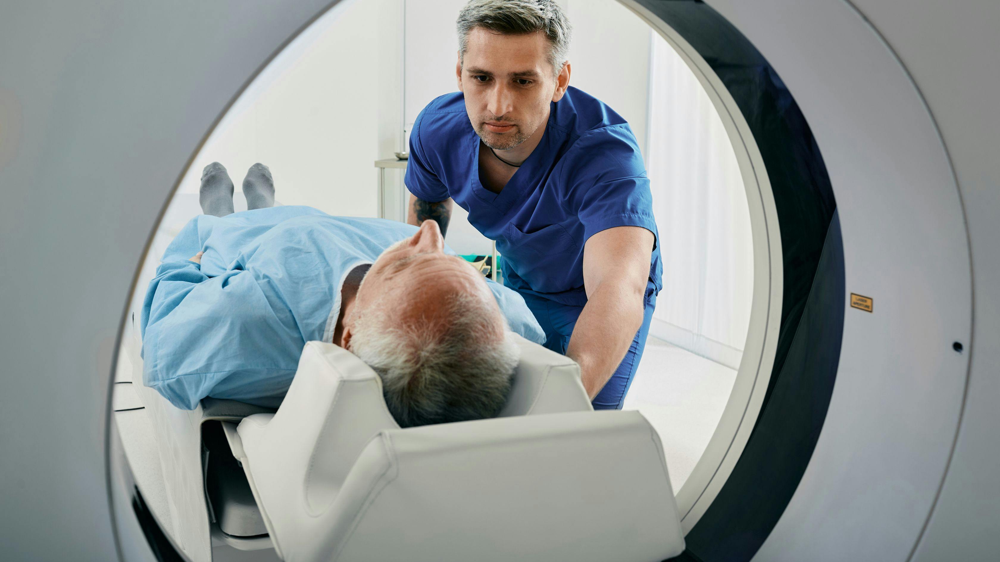 a man is getting a ct scan in a hospital .
