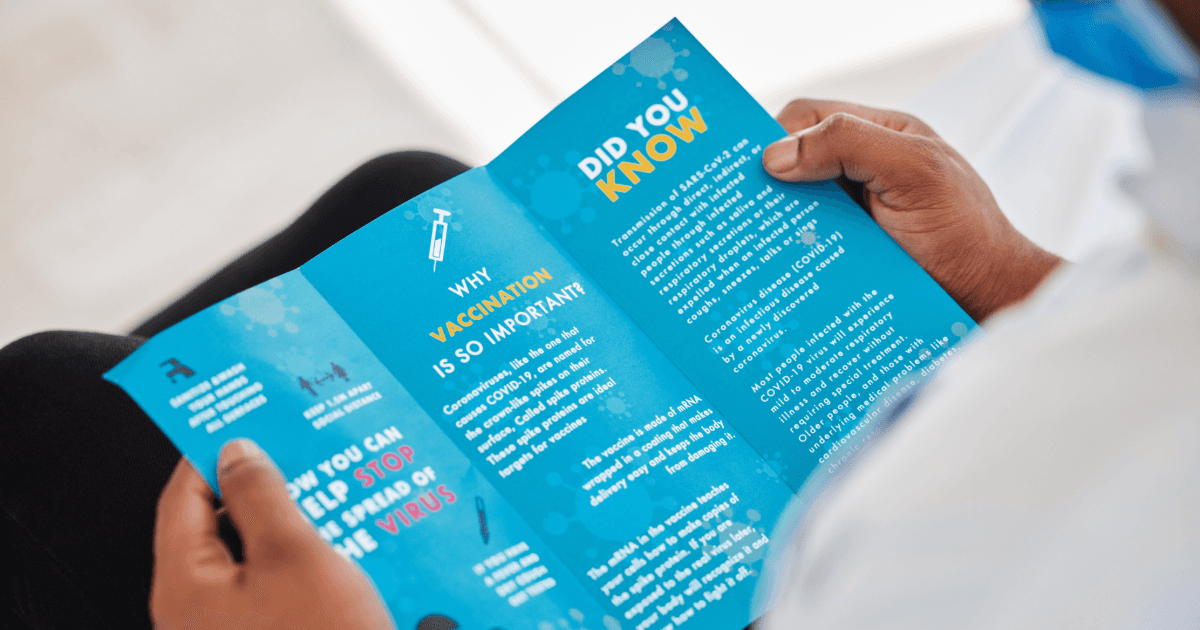 a person is reading a brochure about why vaccination is so important