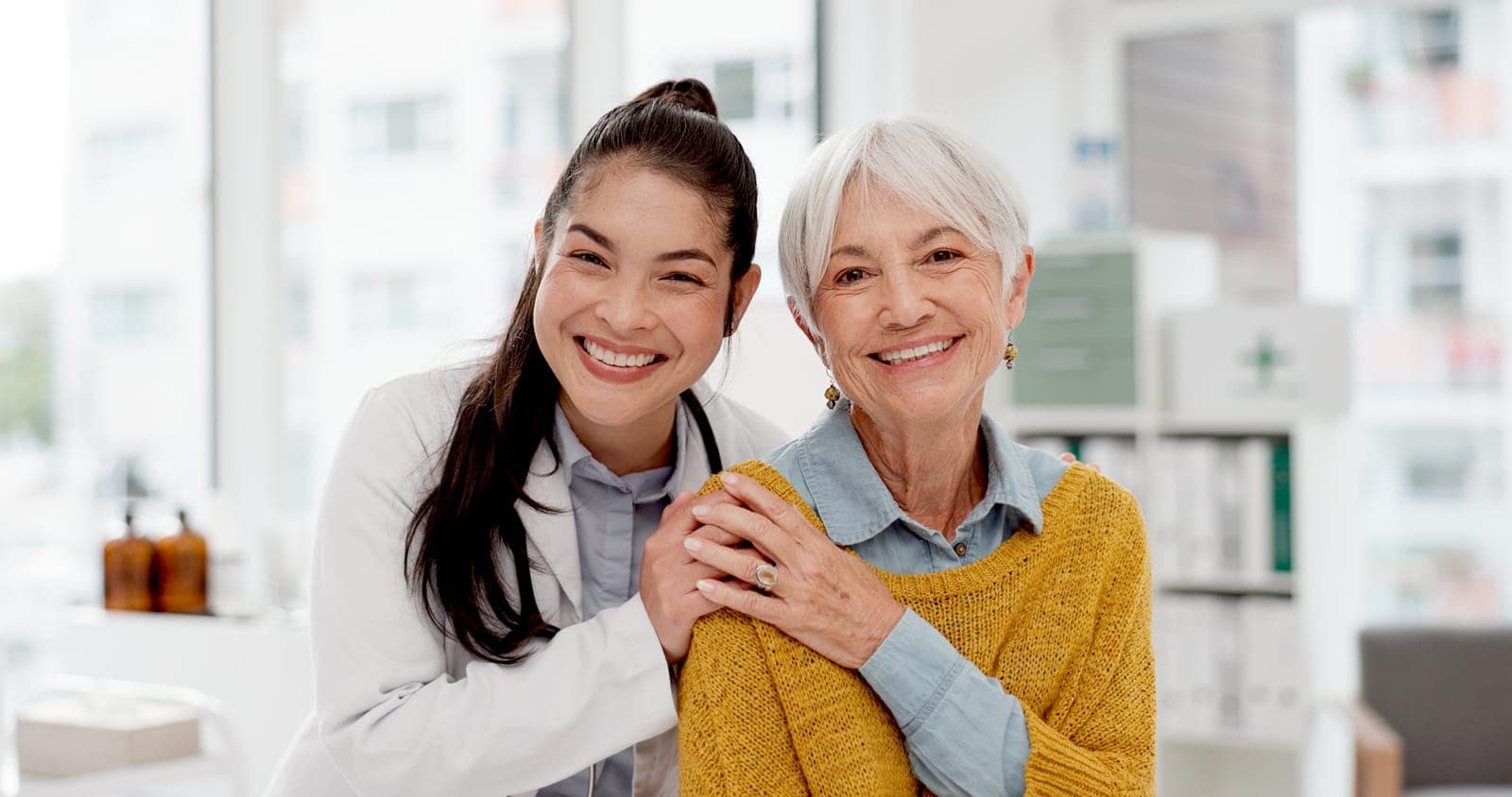 a doctor is hugging an older woman in a pharmacy .
