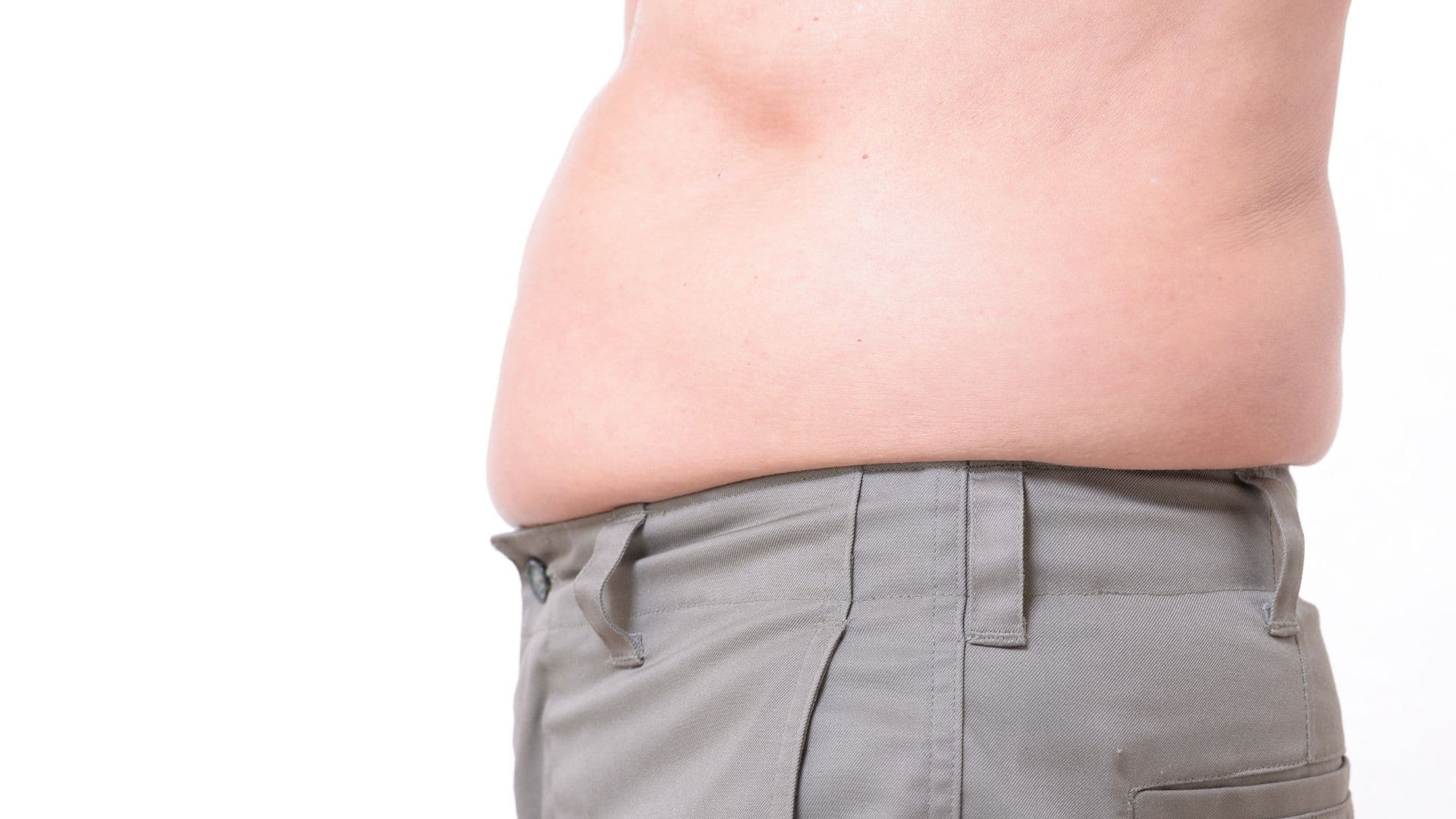 a man with a large belly is wearing gray pants .