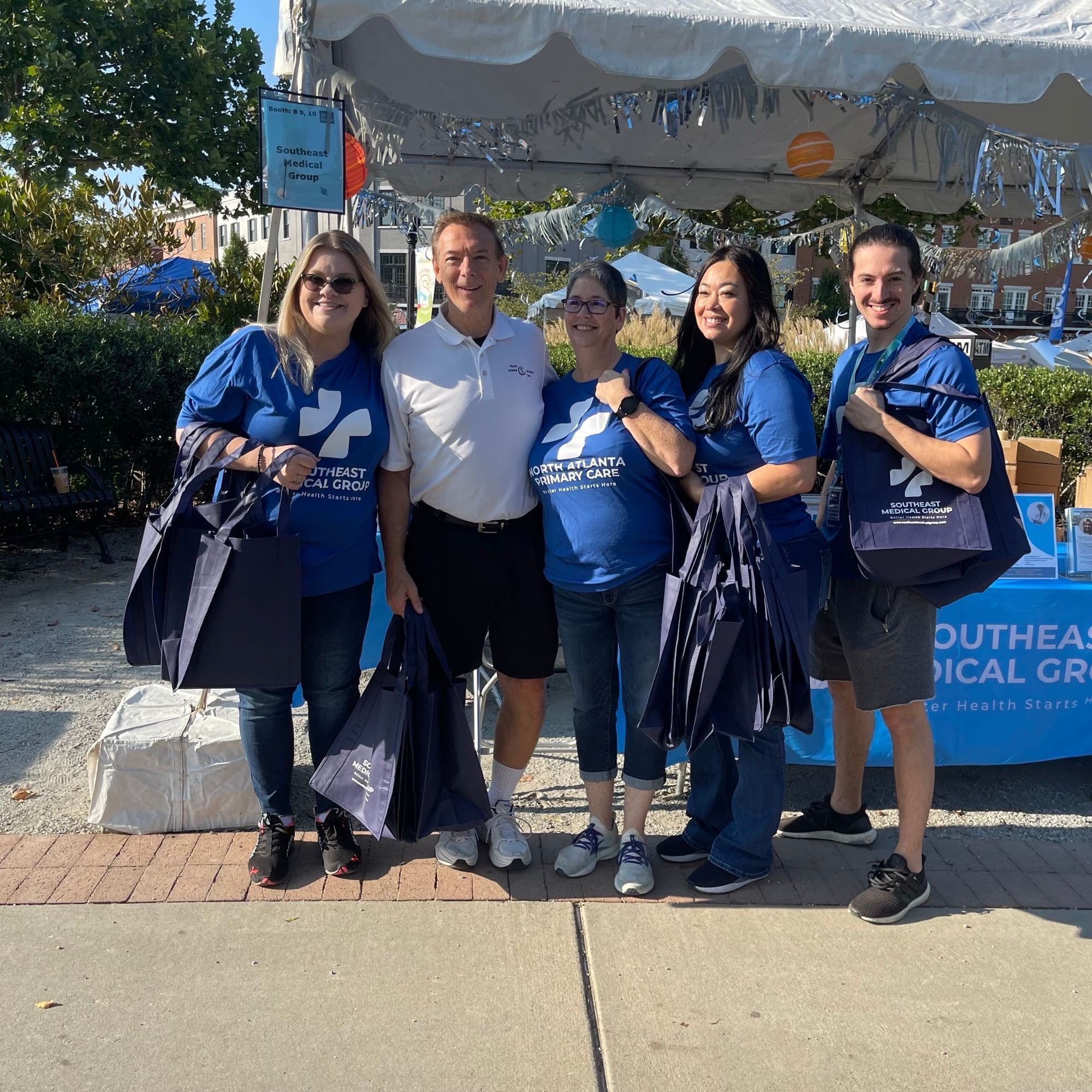 a group of people are posing for a picture in front of a table .
