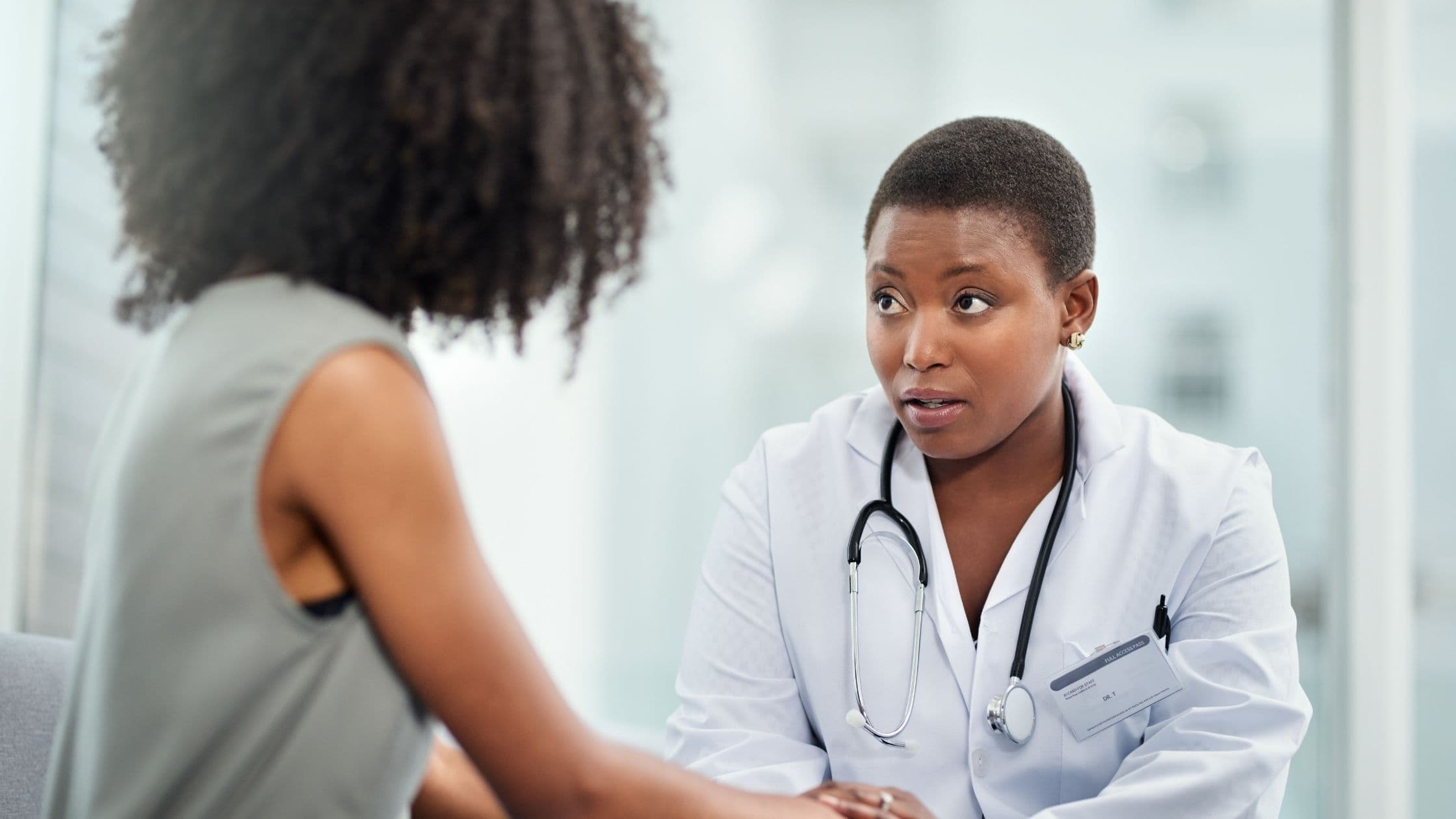 a doctor is talking to a patient in a hospital room .