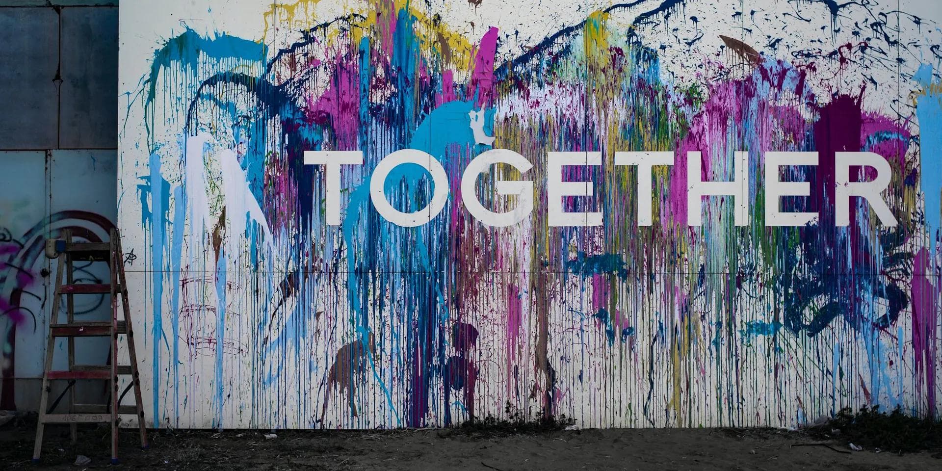 a colorful mural on a wall that says `` together '' .