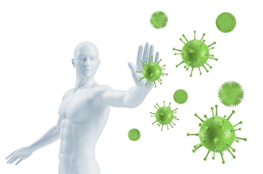 a man is standing in front of a group of green bacteria .