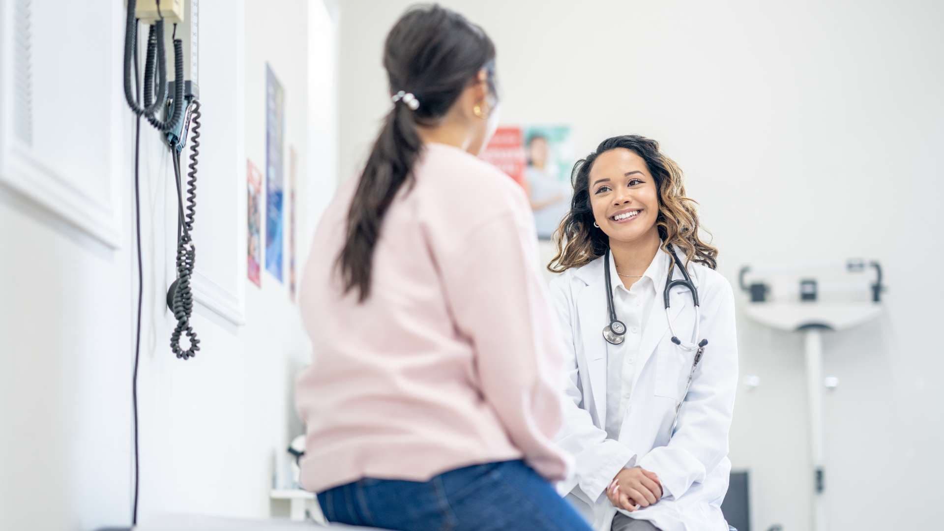 a doctor is talking to a patient in an office .