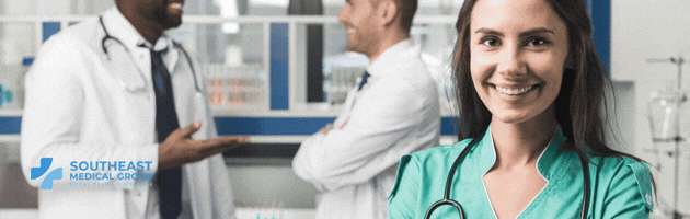 A smiling female medical professional in scrubs, with two male doctors in the background and the Southeast Medical Group logo.