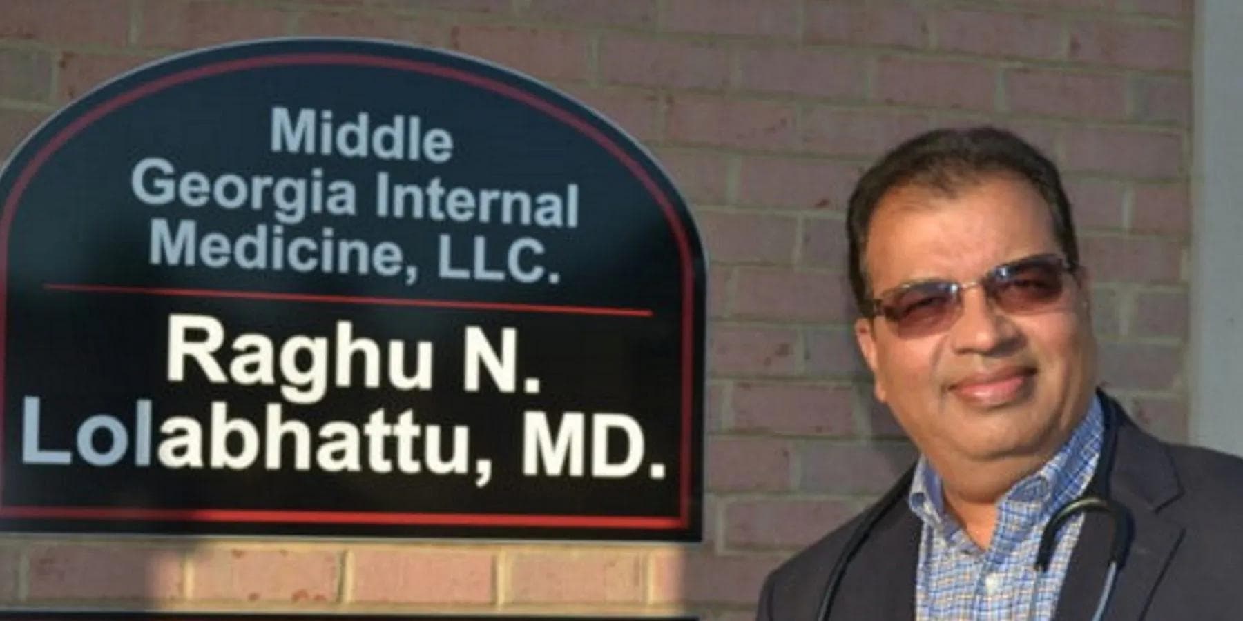 a man standing in front of a sign that says middle georgia internal medicine llc
