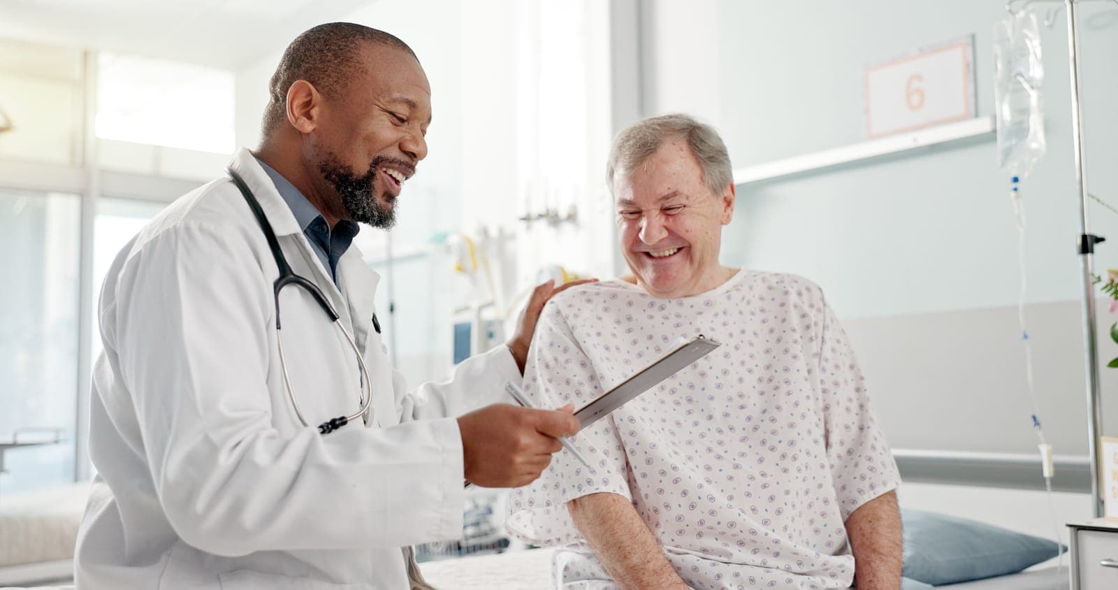 a doctor is talking to a patient in a hospital bed .