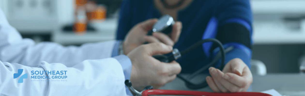 A doctor measures a patient's blood pressure. The Southeast Medical Group logo is in the bottom left.