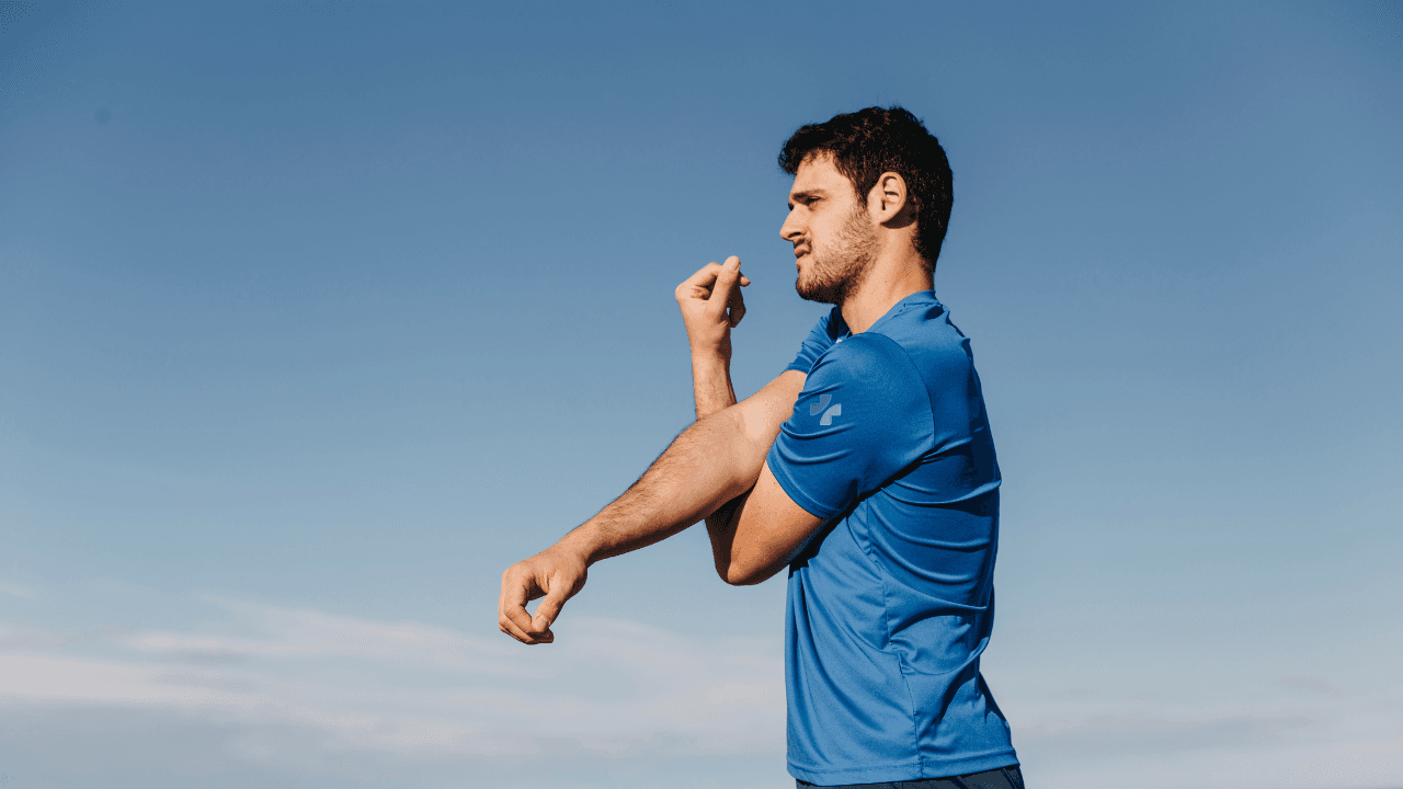 a man in Southeast Medical Group shirt stretching his arms