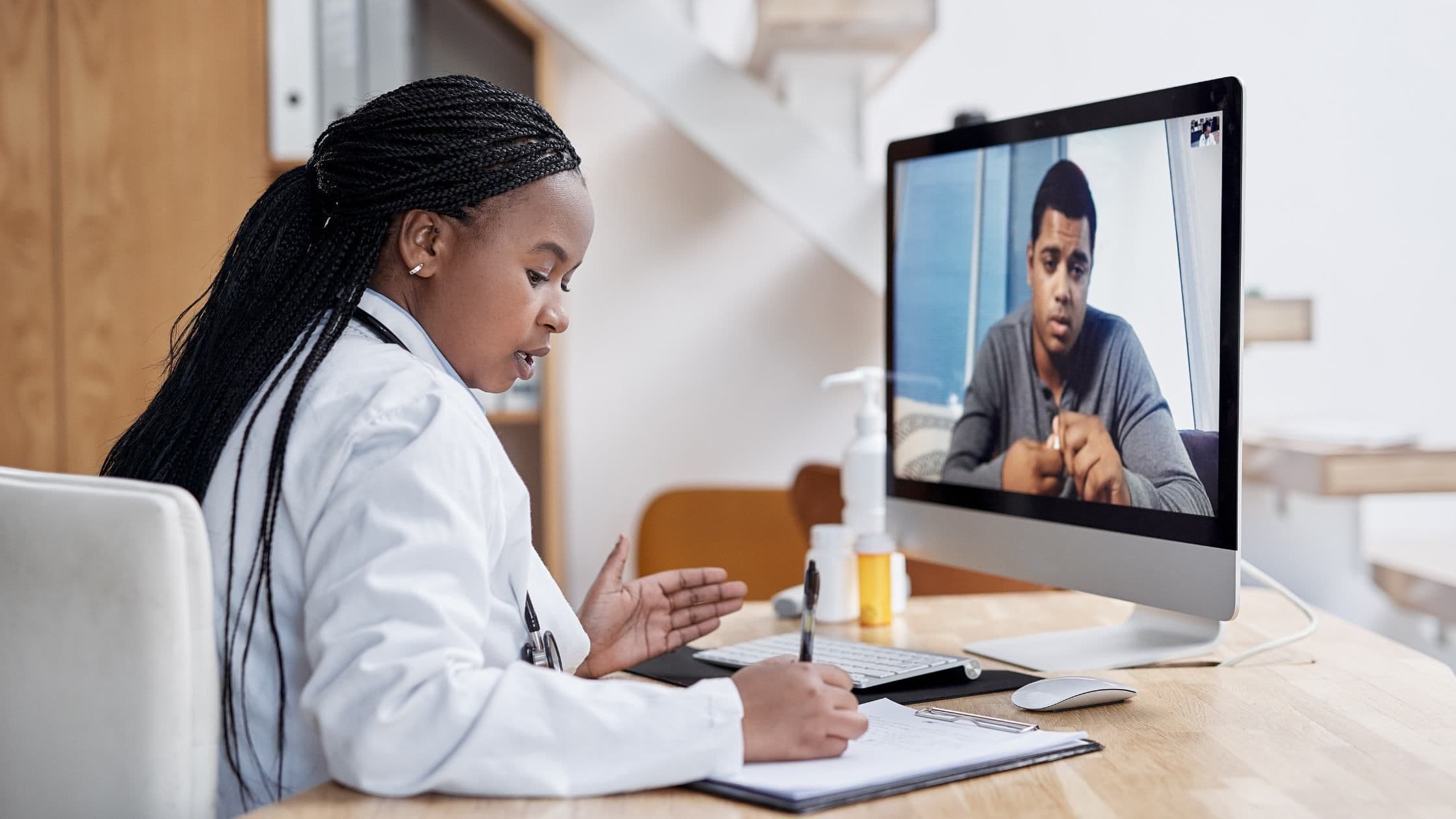 a doctor is having a video call with a patient .