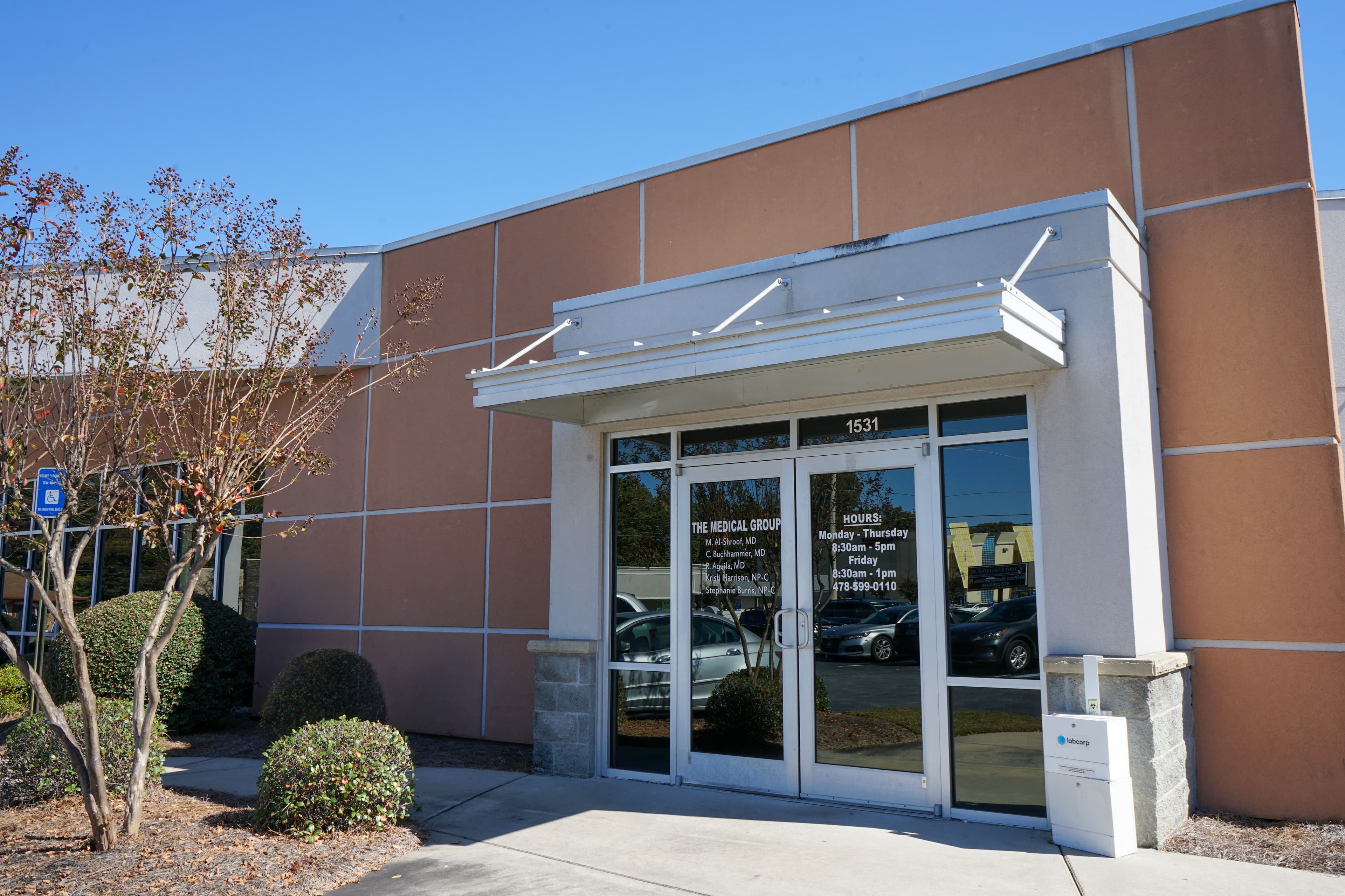 the front of a large building with a canopy over the entrance .