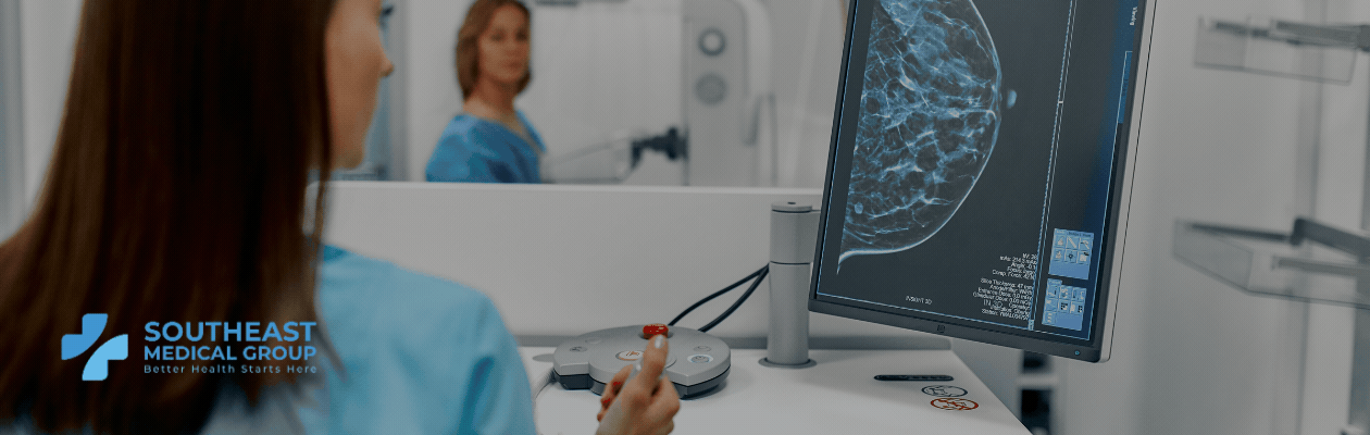 Medical professional viewing a mammogram on a screen, with a patient and medical equipment in the background. Southeast Medical Group logo.