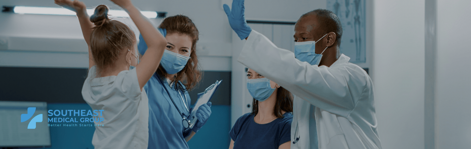 A young girl, nurse, and doctor, all wearing masks, high-five each other.