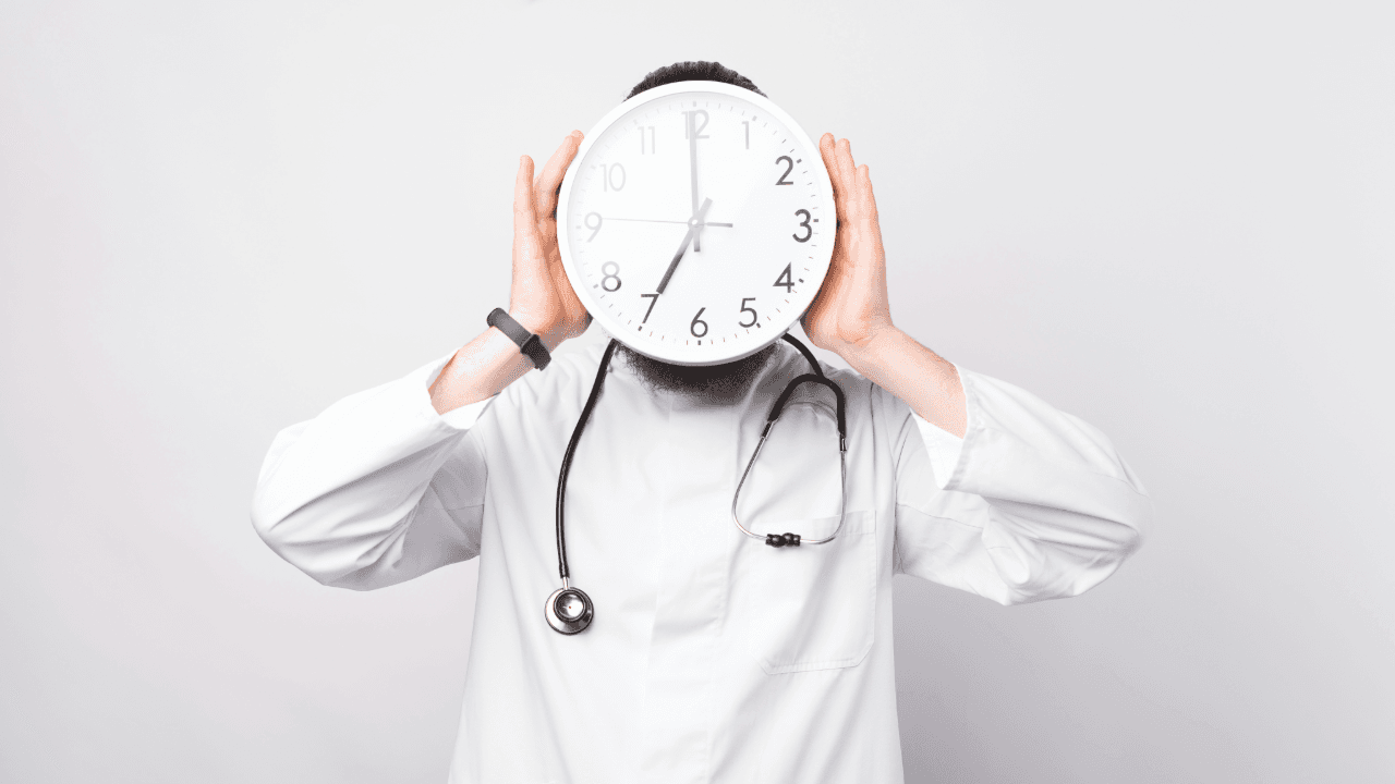 a doctor with a stethoscope covering his face with a clock