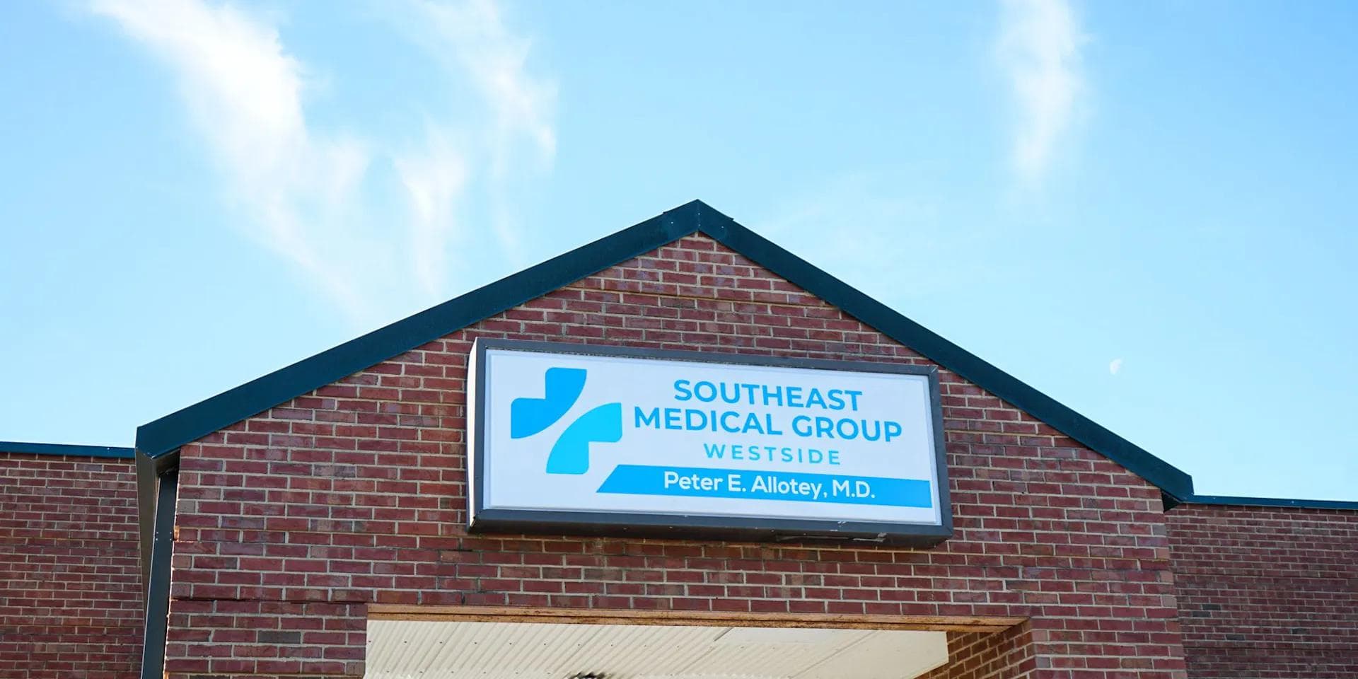 the front of a brick building with a sign for southeast medical group westside .