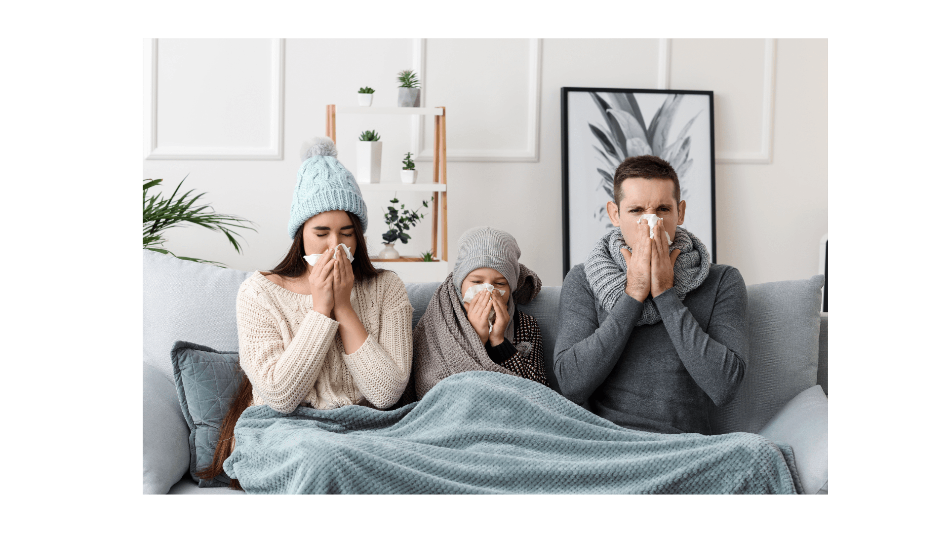 a family is sitting on a couch blowing their noses
