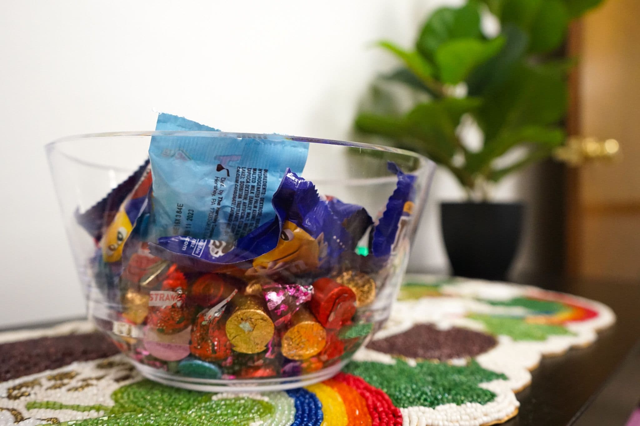 a bowl filled with candy is sitting on a table .