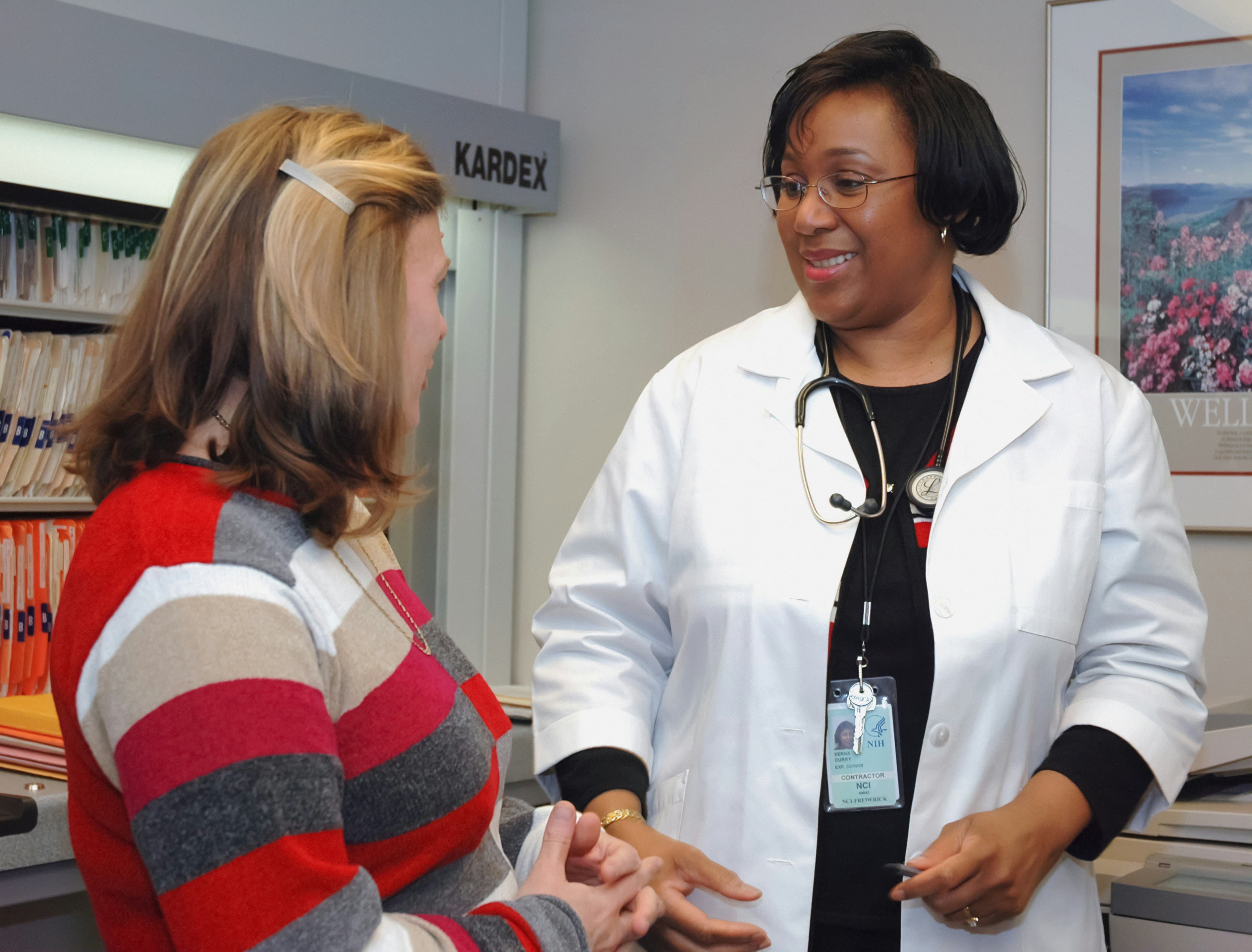 a doctor is talking to a patient in a hospital room .