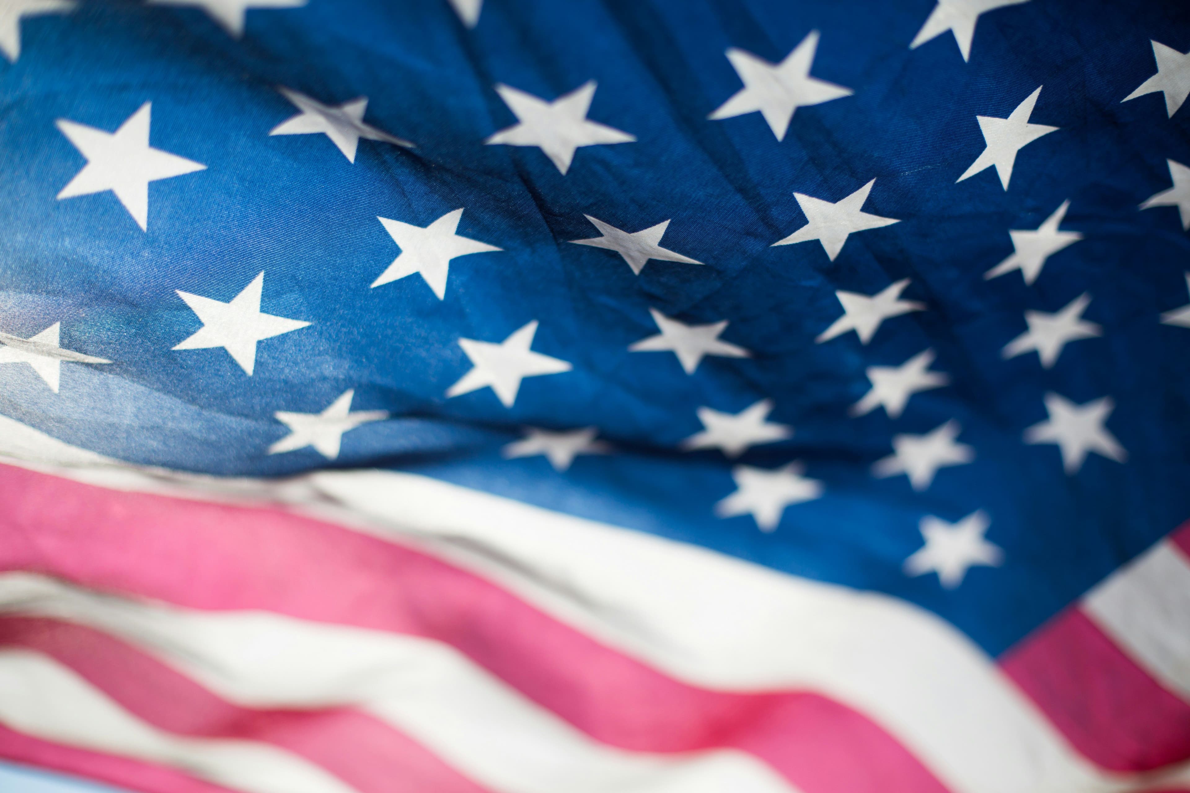 a close up of an american flag waving in the wind .