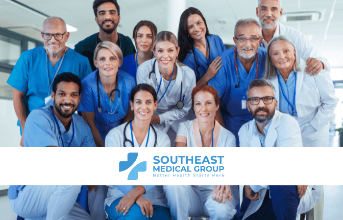 A diverse group of smiling medical professionals in a healthcare setting, with the Southeast Medical Group logo.