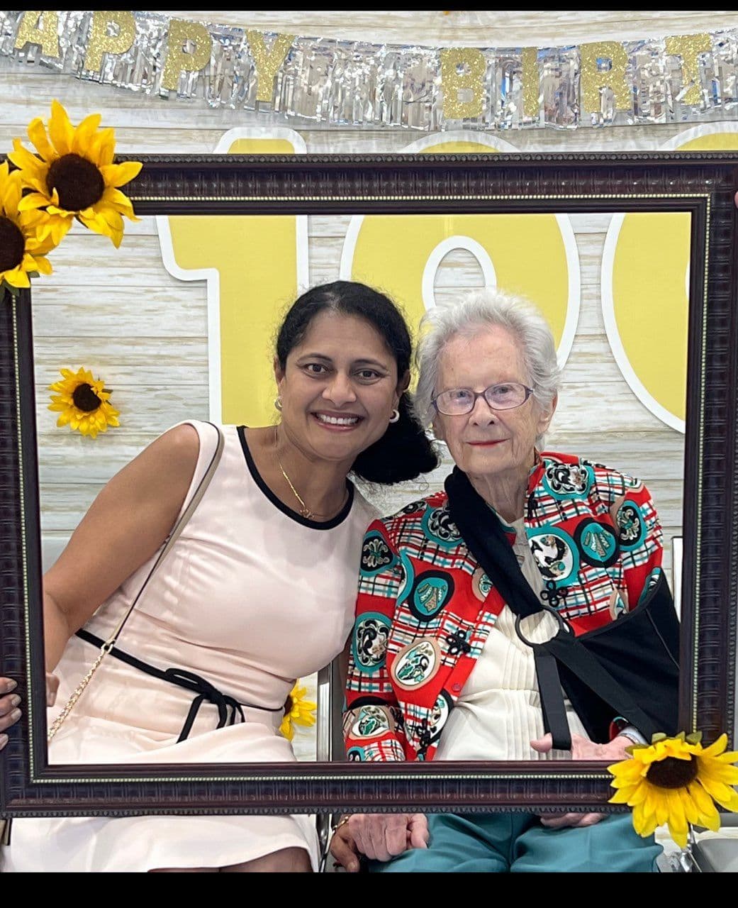 a woman and an elderly woman are posing for a picture